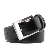 Black leather belt coiled with a brushed nickel pin buckle and two keeper loops
